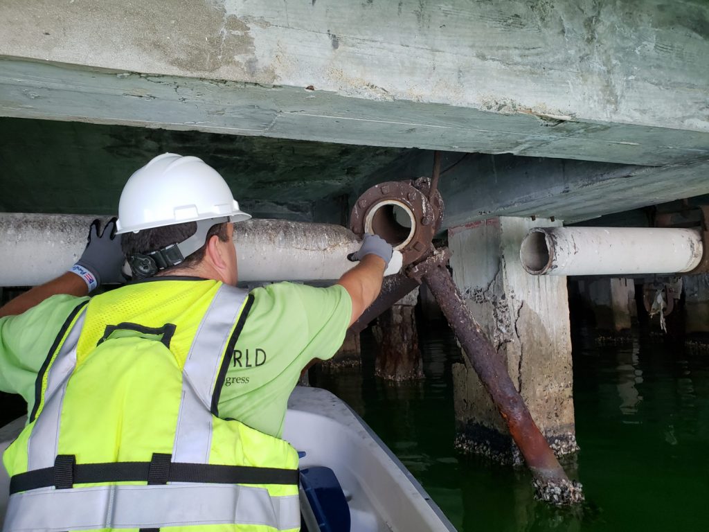 Paul Calabrese inspecting damage under a bridge structure