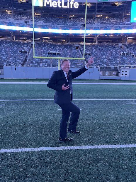 man showing three fingers on the football stadium
