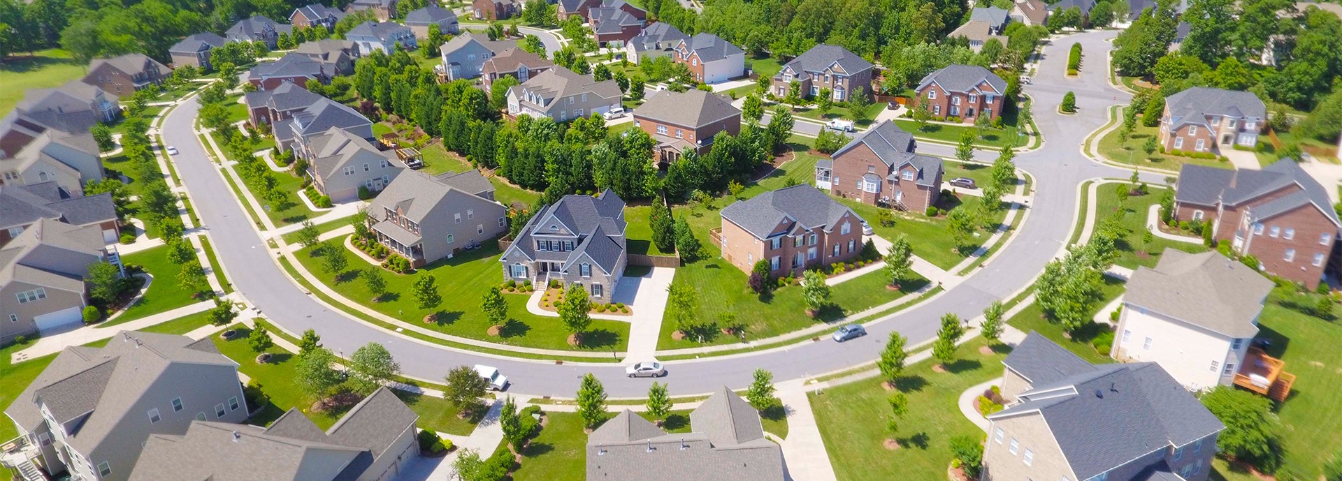 aerial shot of housing development site suburban street