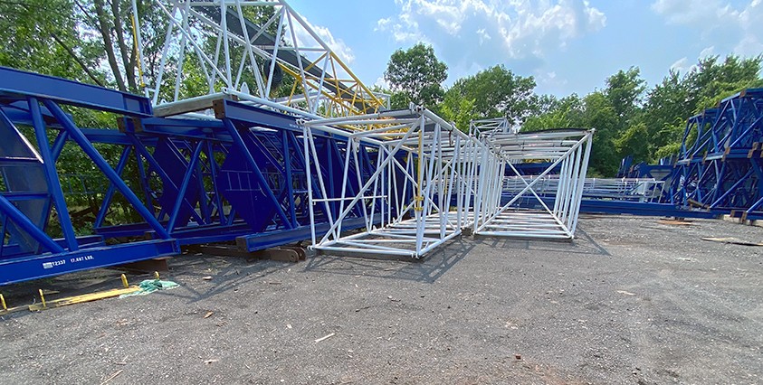 blue and white steel structure on gravel