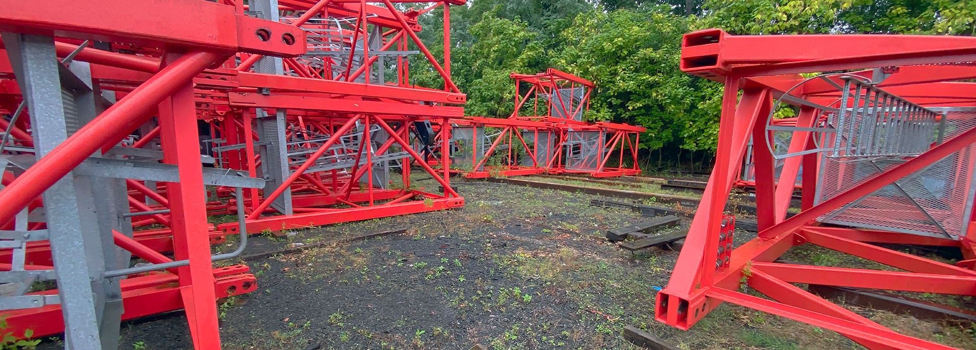 close up of red steel structures on gravel