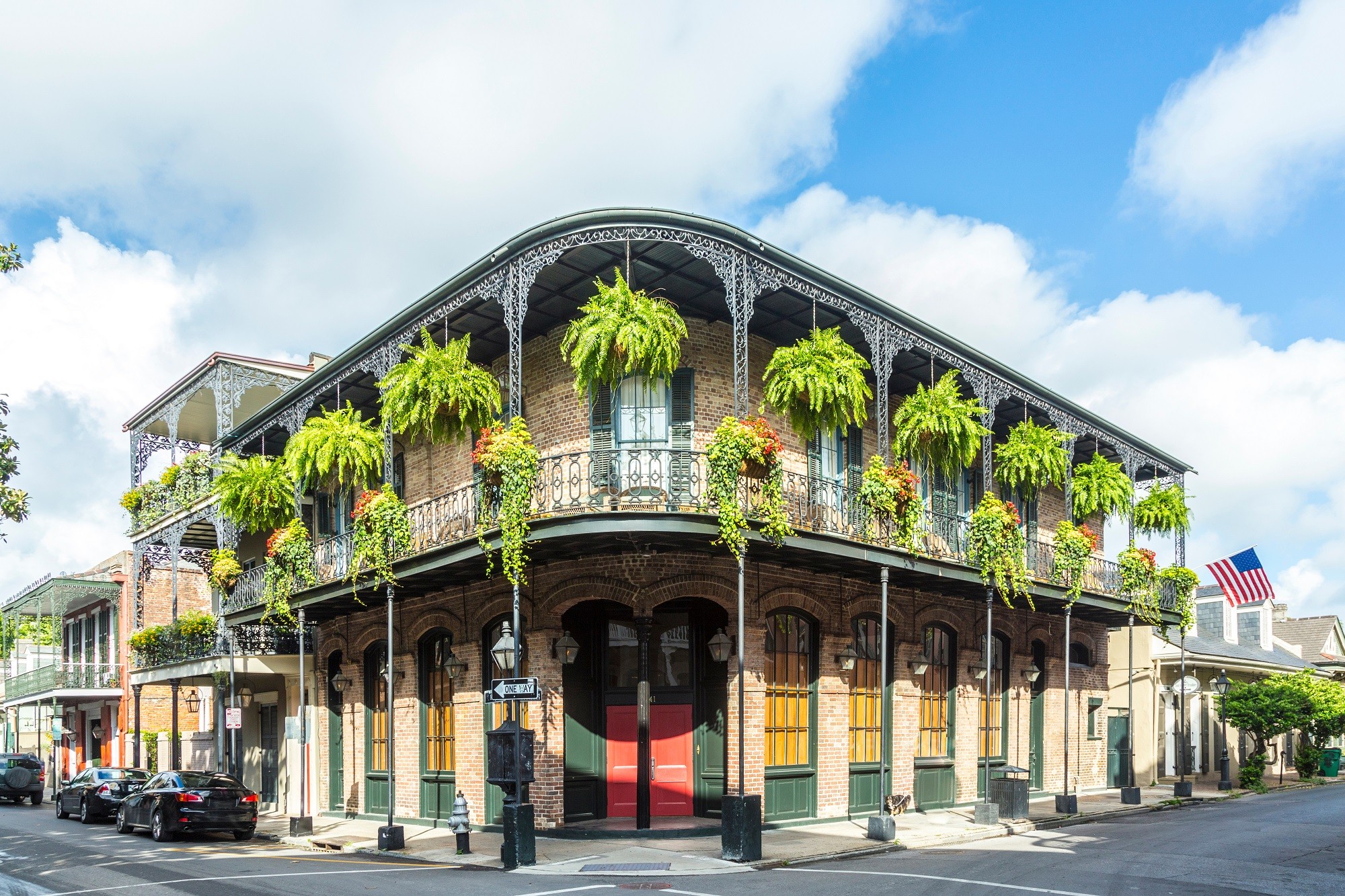 historic building of new orleans la, corner shot of building with hanging plants