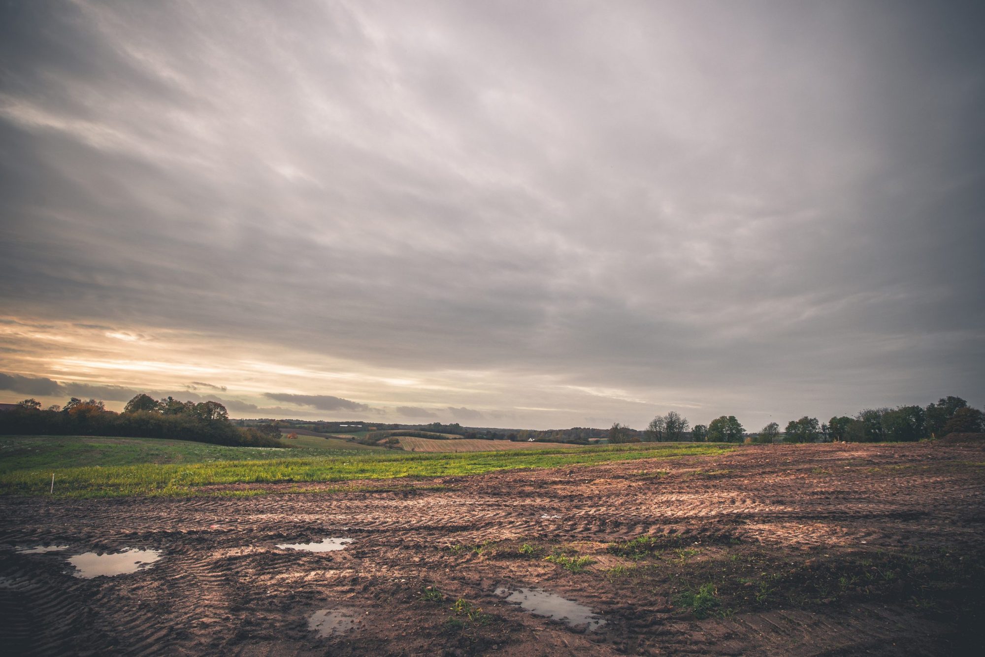 dirt field with cloudy sky