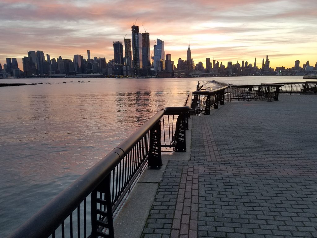 Sunset view of skyline from waterfront walkway