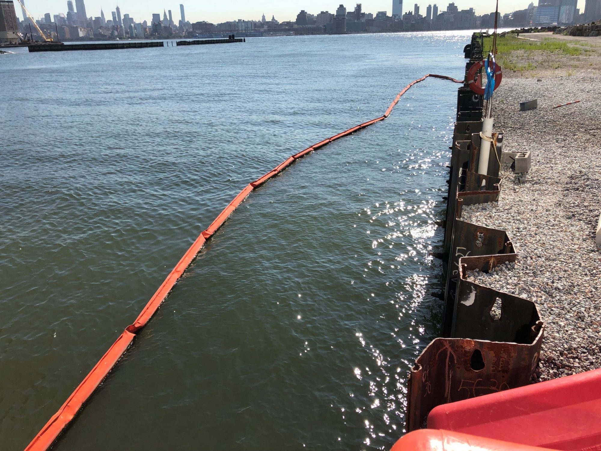 marina wall view into water with cleanup effort