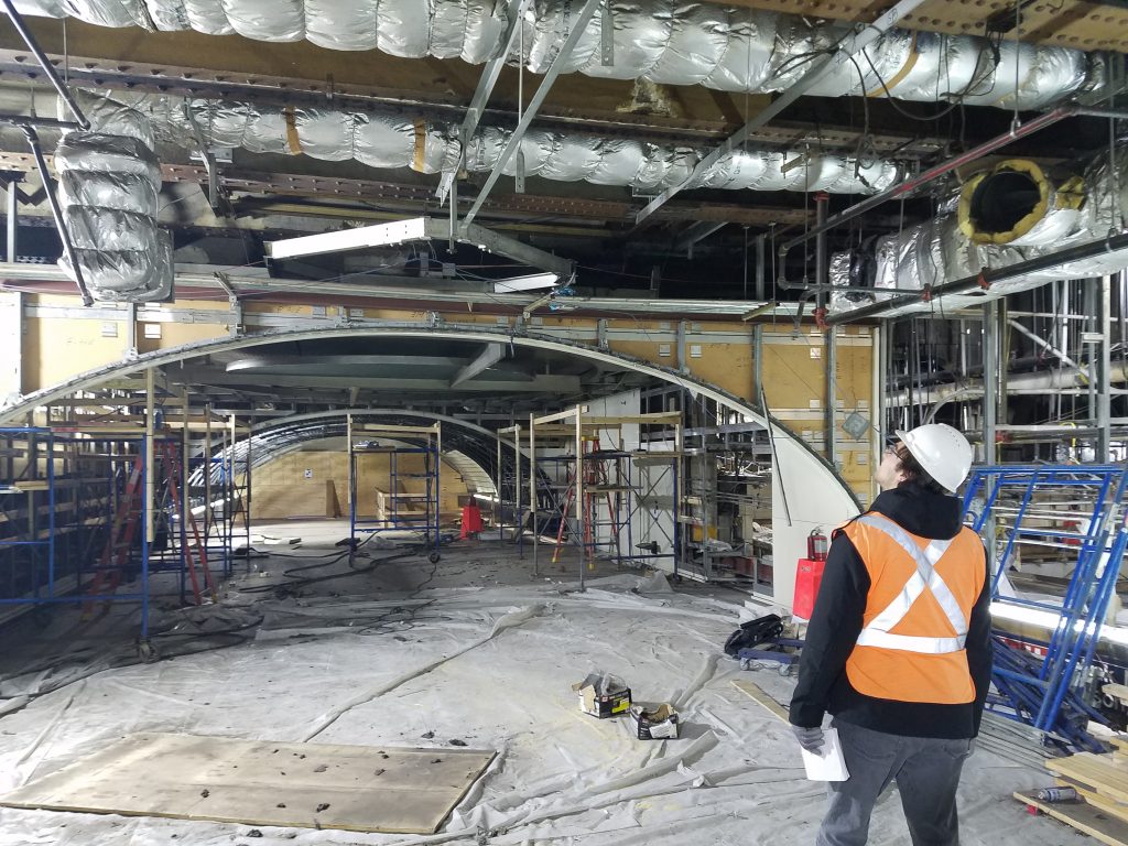 worker looking up at a construction work site