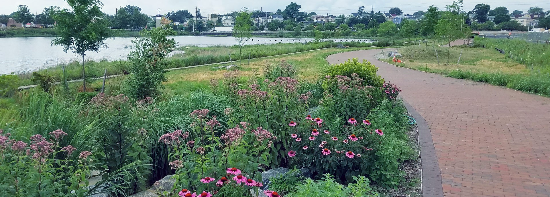 brick walkway with garden flowers on waterfront in bayonne nj