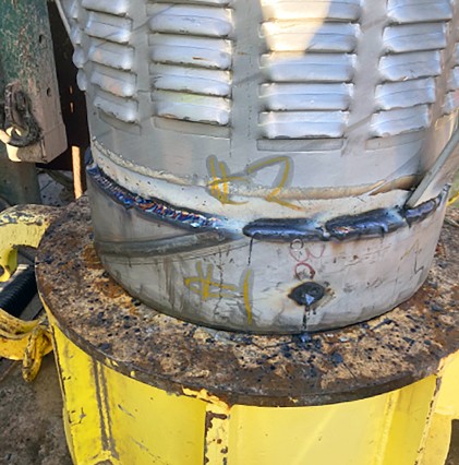 close up of well drill with yellow on bottom