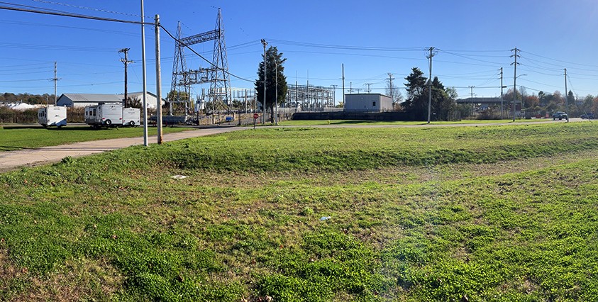 view of facility in distance with grass in foreground