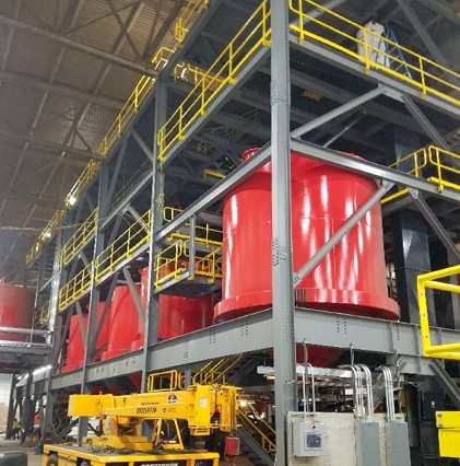 view of steel shelves with giant red drums in facility