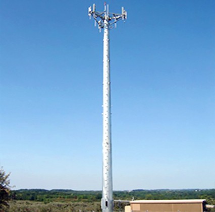 radio tower in front of blue cloudless sky