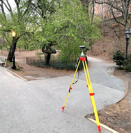 survey equipment on path in riverside park