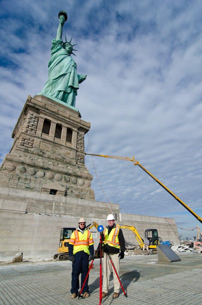 surveyors in front of statue of liberty