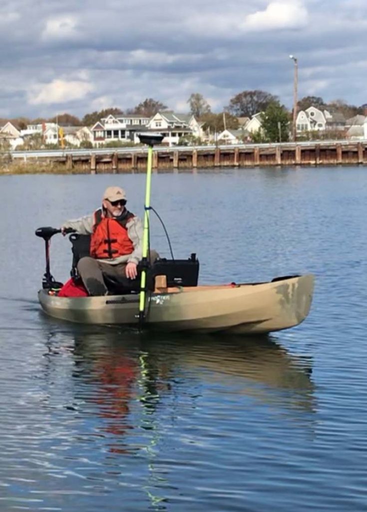 bert wyness in a small boat with bathymetric survey equipment