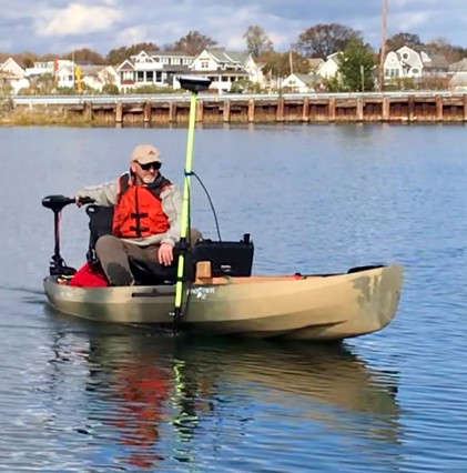 bert in boat with survey equipment on water with bridge in background