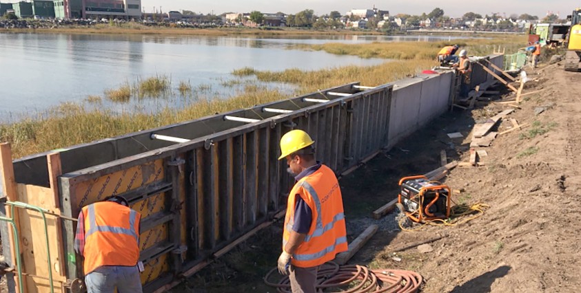 workers on project site with bulk head on shoreline in bayonne