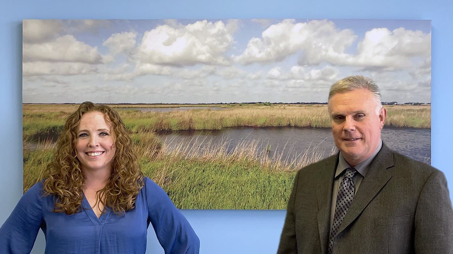 kim threlfall and paul stanton standing in front of marsh image