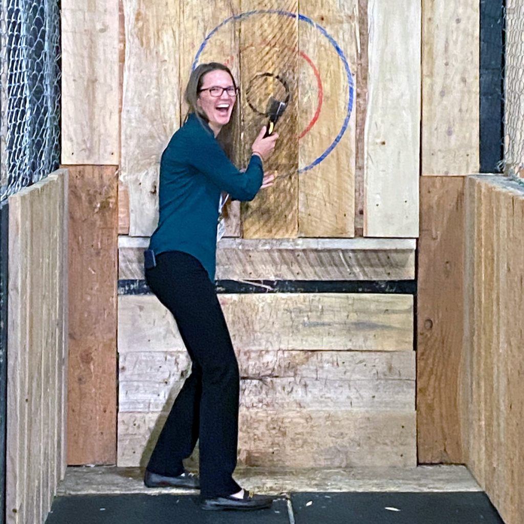 matrix employee posing in front of bullseye with hatchet