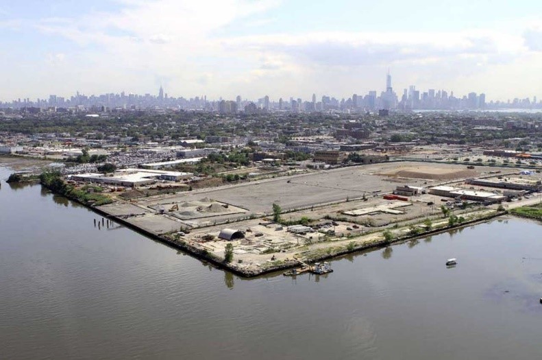 urban area on water planned for redevelopment with skyline far in background